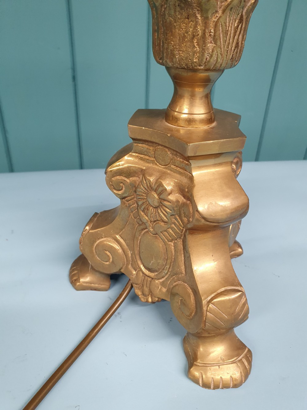 An early 20th-century Baroque revival cast brass candlestick table lamp with a scrolled tripod base and turned stem. View VIII