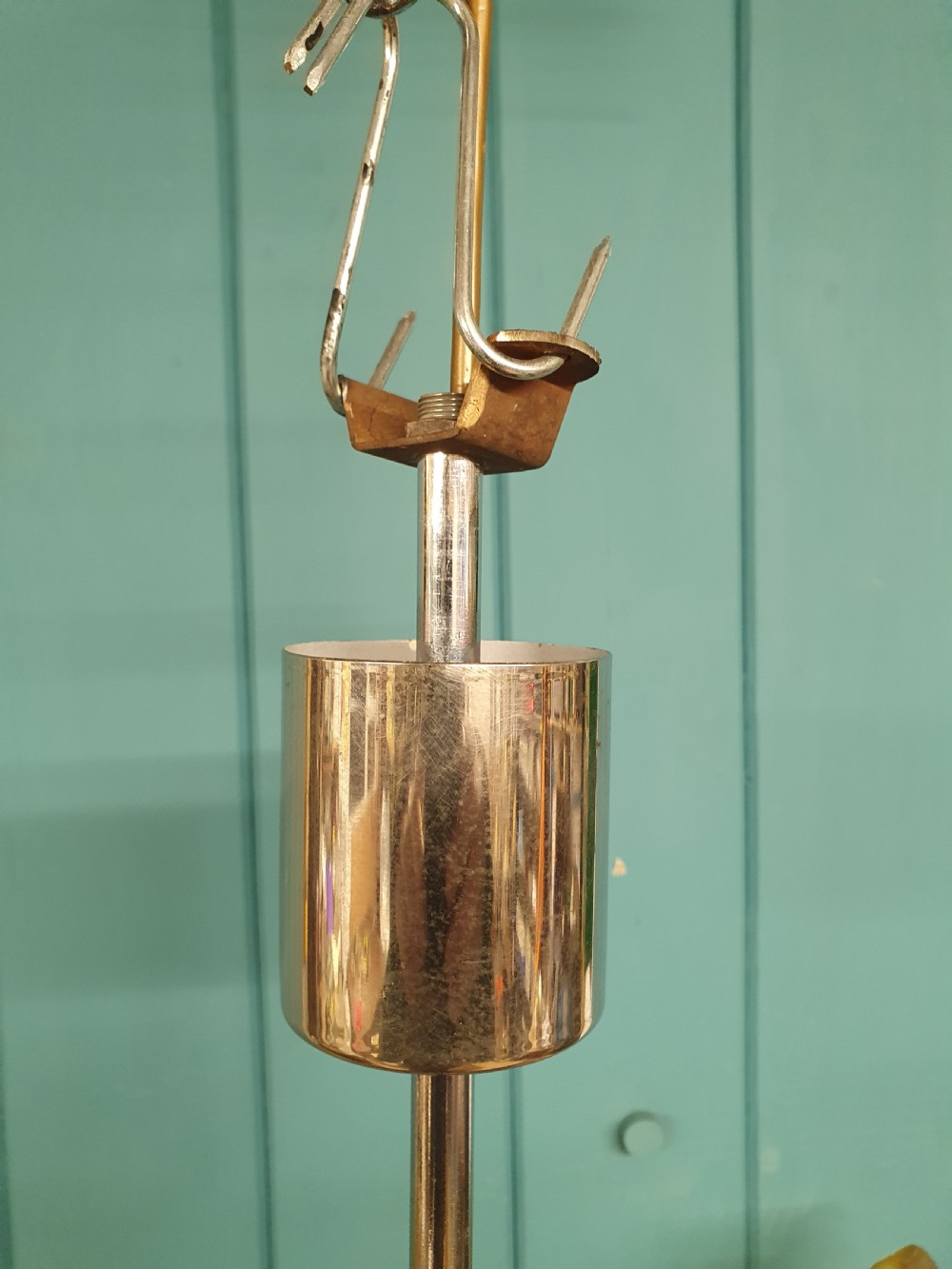 An Art Deco three-light chandelier featuring chrome stems, orange torch holders, and flame-shaped frosted glass shades. View II