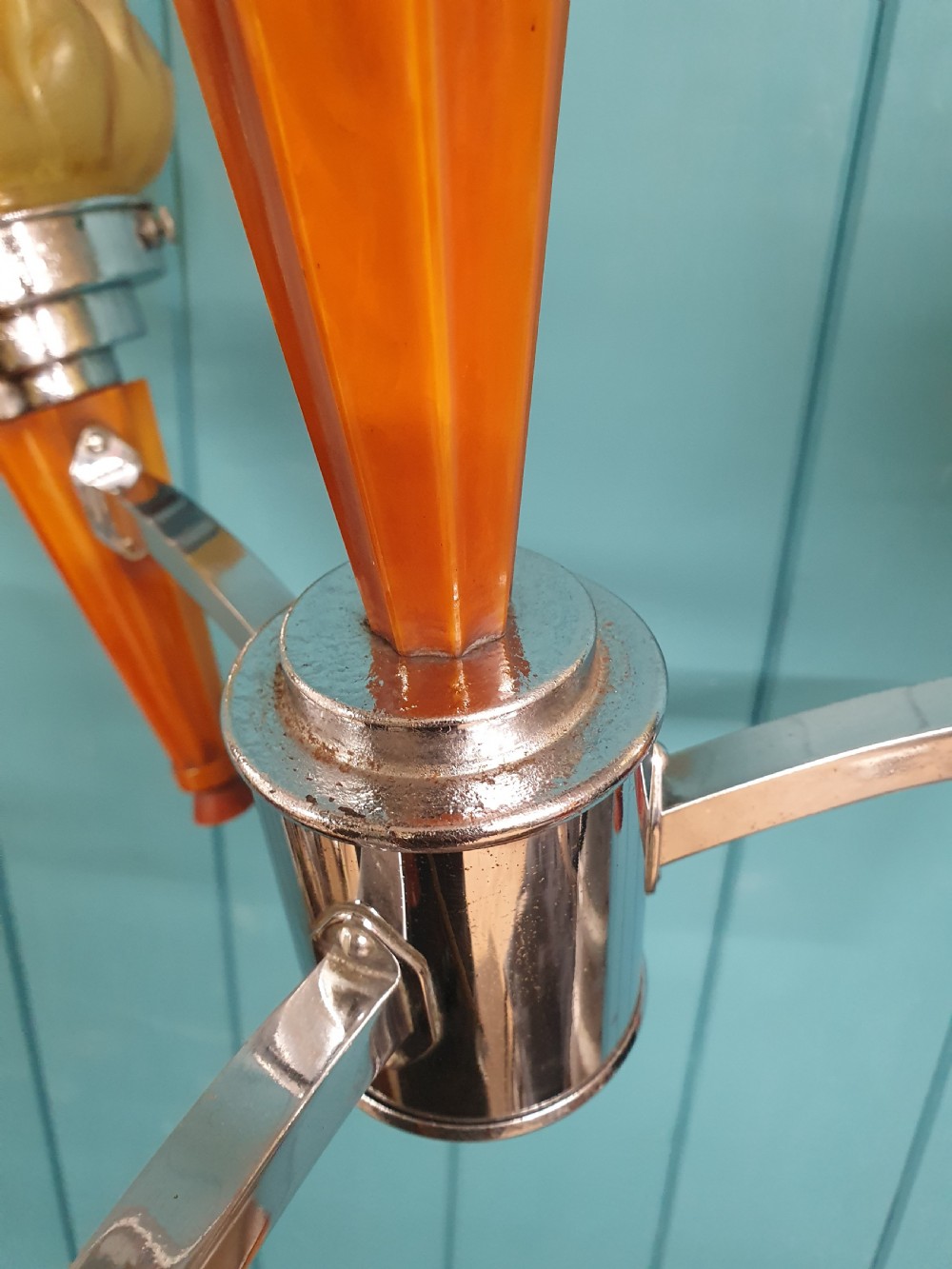 An Art Deco three-light chandelier featuring chrome stems, orange torch holders, and flame-shaped frosted glass shades. View VIII