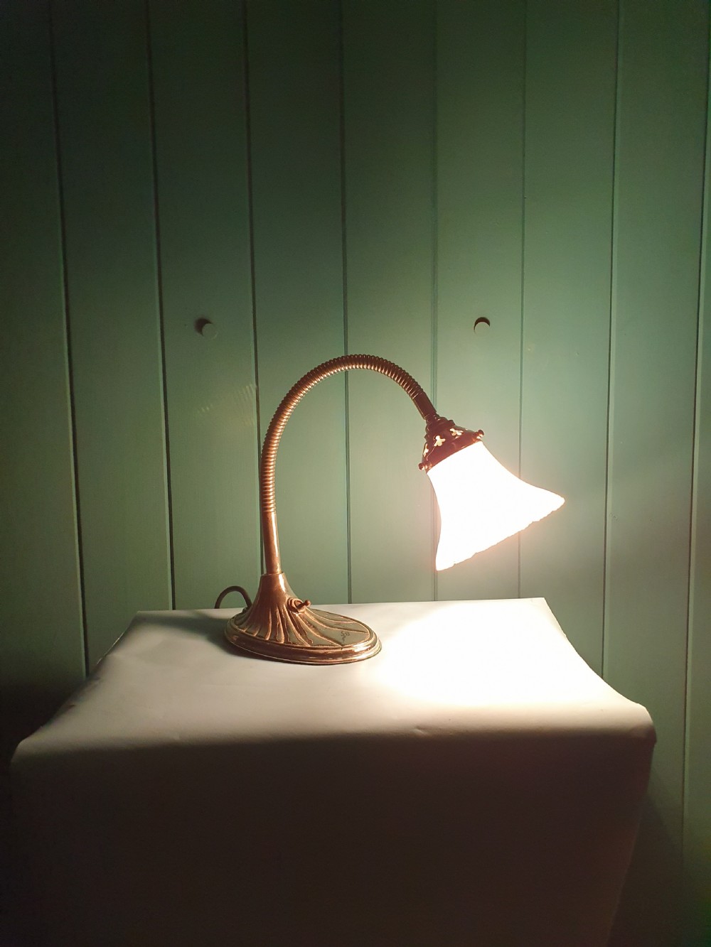 An Art Deco brass desk lamp featuring a shell-shaped base, flexible gooseneck arm, and a fluted clear glass shade. View II