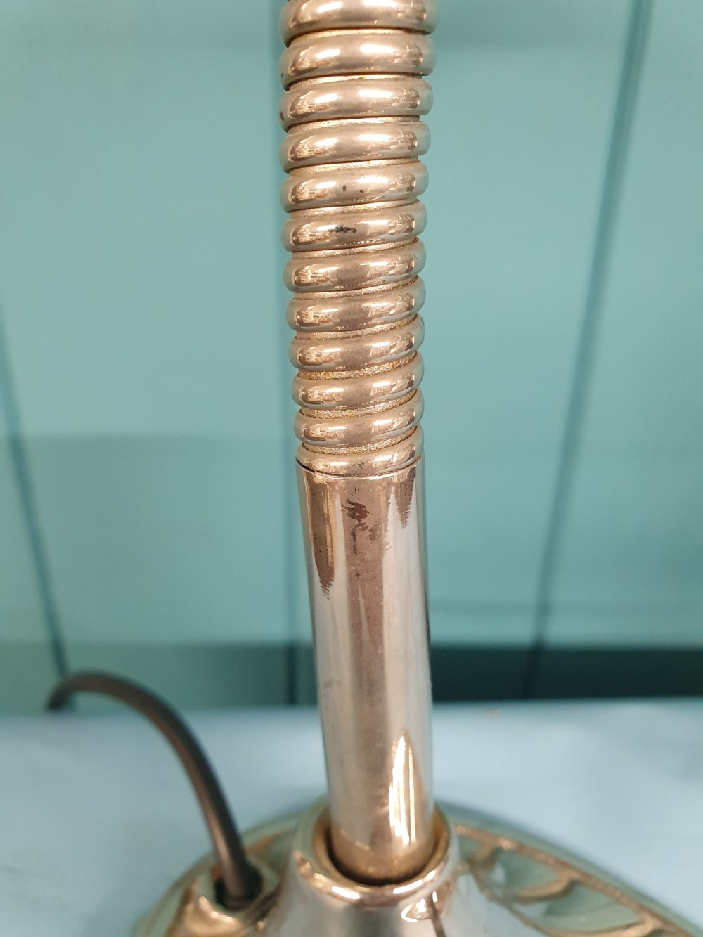 An Art Deco brass desk lamp featuring a shell-shaped base, flexible gooseneck arm, and a fluted clear glass shade. View IV