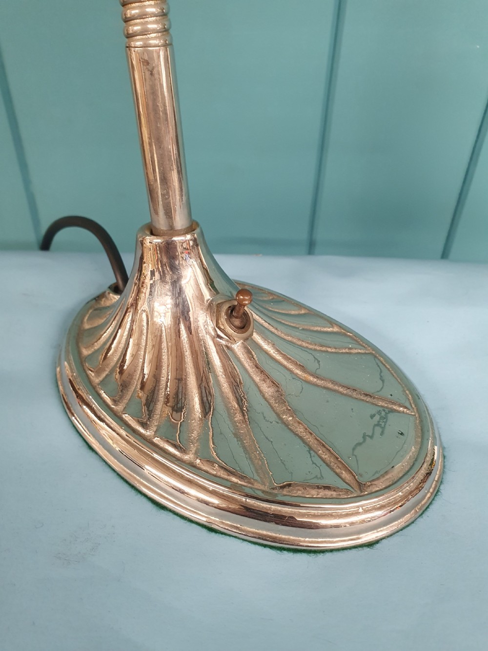 An Art Deco brass desk lamp featuring a shell-shaped base, flexible gooseneck arm, and a fluted clear glass shade. View V