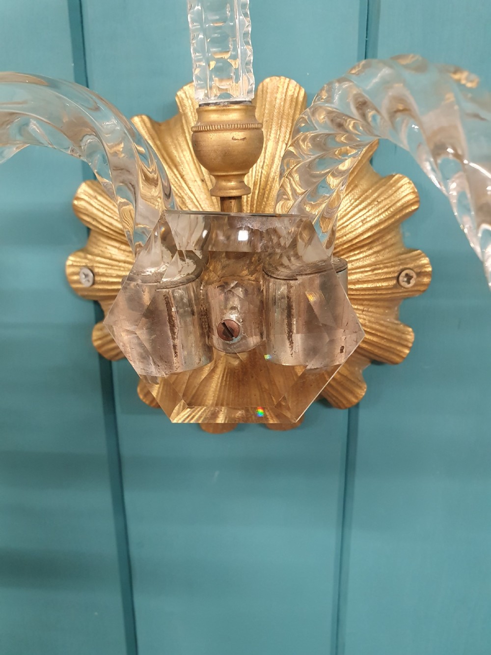 A pair of early 20th-century French double-arm glass wall sconces with crystal droplets, gilt brass backplates, and black lampshades. View IV