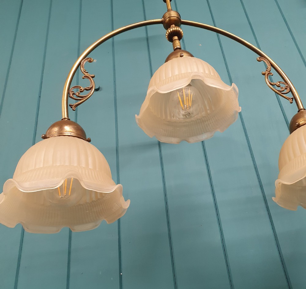 Edwardian three light brass chandelier with glass shades 23