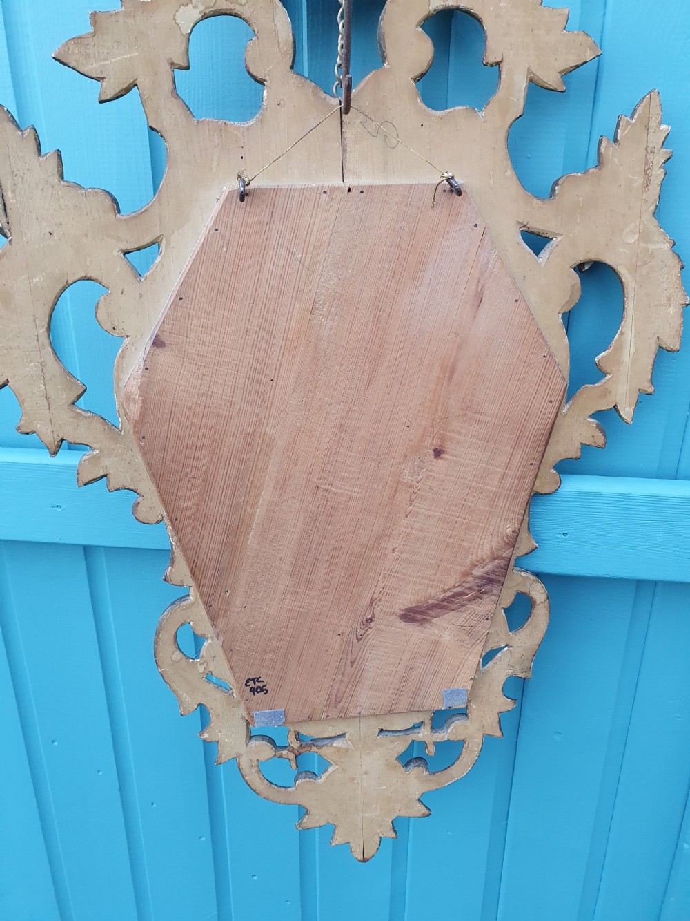 A matching pair of carved Italian Rococo style giltwood wall mirrors featuring leaf crests and elaborate floral scrollwork. View VI