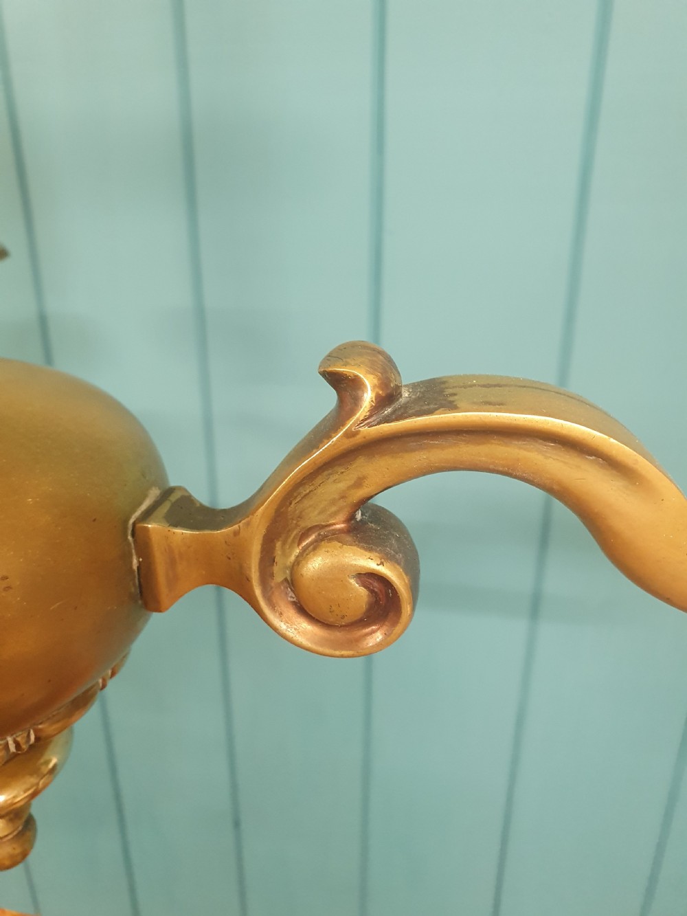 A three-arm Dutch Flemish style brass chandelier featuring a central turned baluster stem and s-scroll arms supporting faux candle sockets. View V