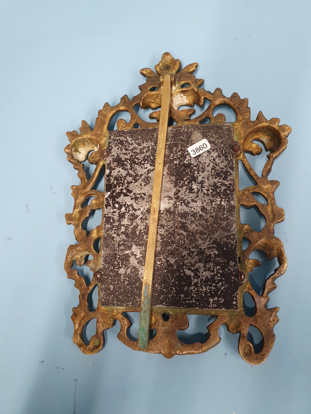 An ornate late 19th-century cast brass table mirror featuring pierced scrollwork frame and an acanthus leaf crest. View II