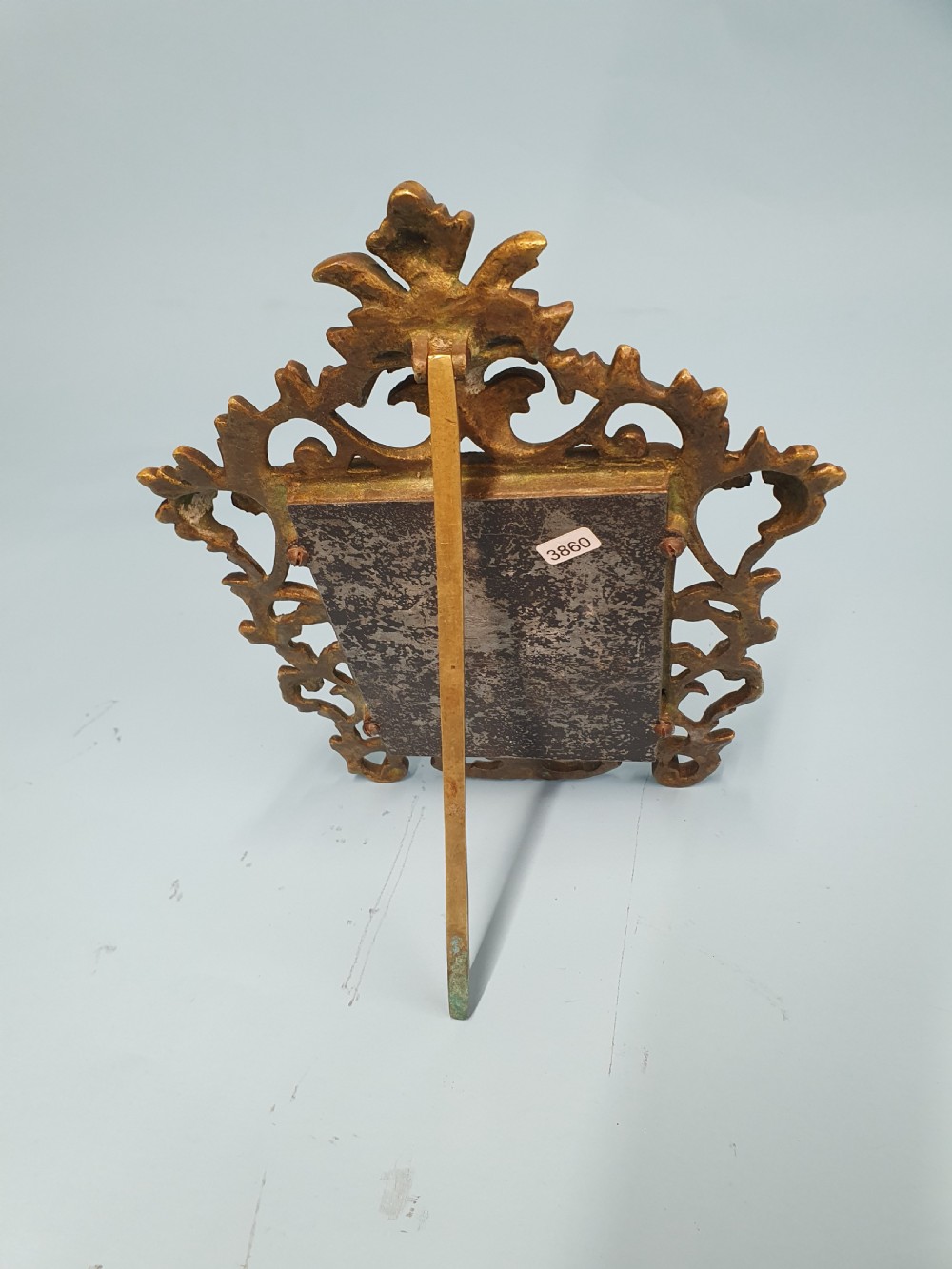 An ornate late 19th-century cast brass table mirror featuring pierced scrollwork frame and an acanthus leaf crest. View III