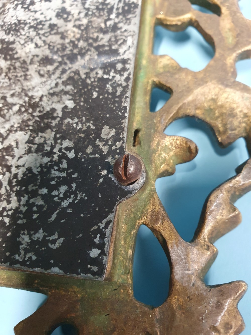 An ornate late 19th-century cast brass table mirror featuring pierced scrollwork frame and an acanthus leaf crest. View IV