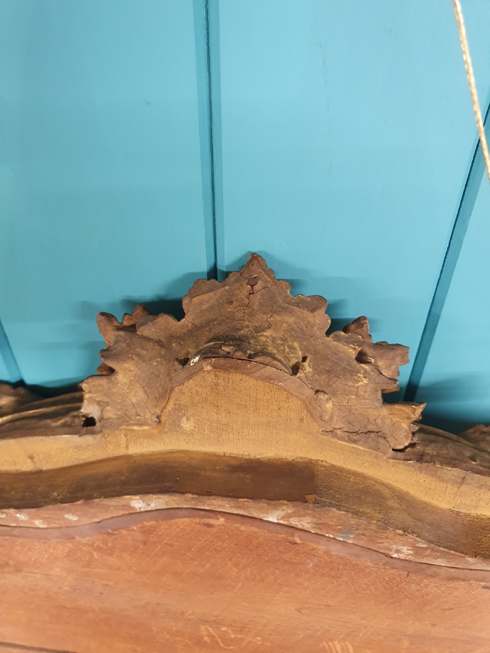 An ornate 19th-century Rococo style giltwood wall mirror featuring carved floral accents, scrollwork, and a decorative inner frame boundary. View VII