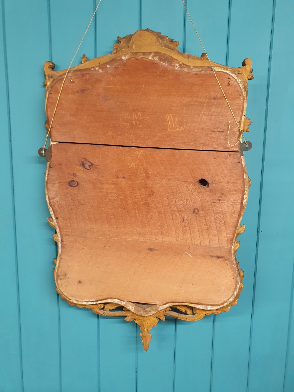 An ornate 19th-century Rococo style giltwood wall mirror featuring carved floral accents, scrollwork, and a decorative inner frame boundary. View VIII