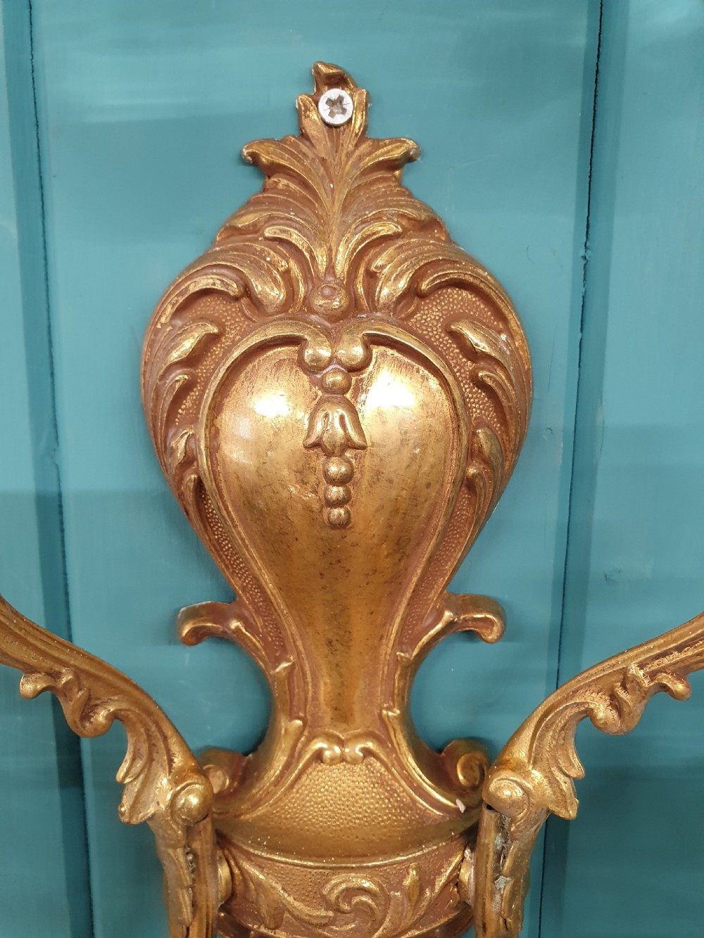 A set of four early 20th-century French Rococo revival gilt brass twin-arm wall sconces decorated with cut crystal glass droplets. View II