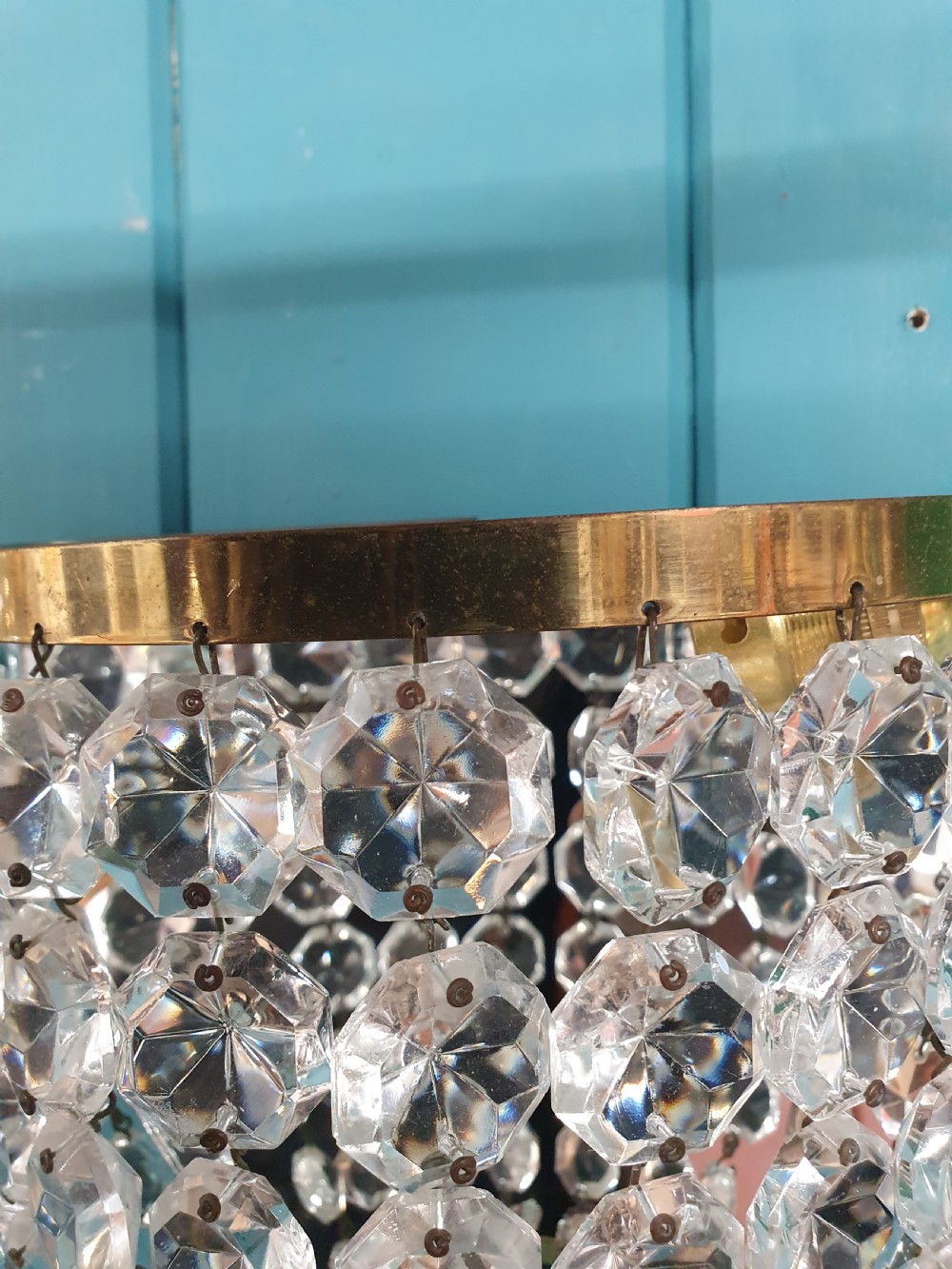 A pair of antique crystal bag wall lights featuring semi-circular pouch frames filled with faceted glass crystal beads below brass bands. View II