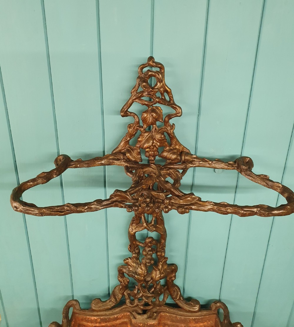 A Victorian cast iron stick stand featuring naturalistic branch and foliage decoration with a drip tray base. View IV