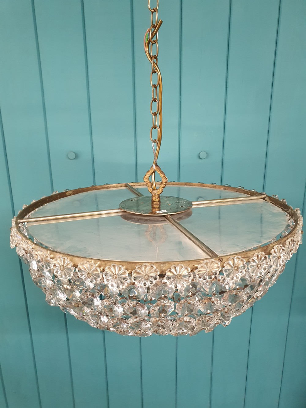 A circular ceiling chandelier featuring suspended octagonal cut glass crystal beads in a basket shape with decorative glass rosettes along the upper rim. View II