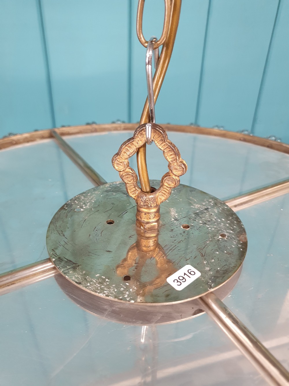 A circular ceiling chandelier featuring suspended octagonal cut glass crystal beads in a basket shape with decorative glass rosettes along the upper rim. View III