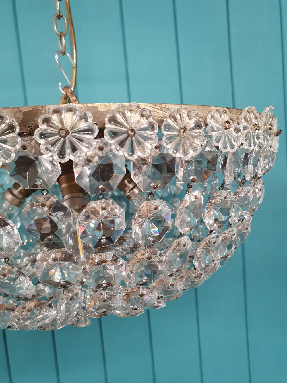 A circular ceiling chandelier featuring suspended octagonal cut glass crystal beads in a basket shape with decorative glass rosettes along the upper rim. View IV