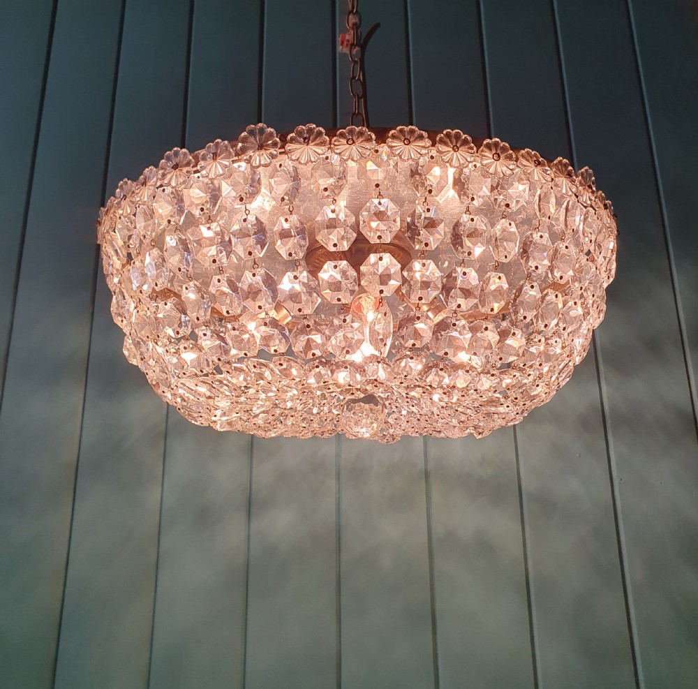 A circular ceiling chandelier featuring suspended octagonal cut glass crystal beads in a basket shape with decorative glass rosettes along the upper rim. View V