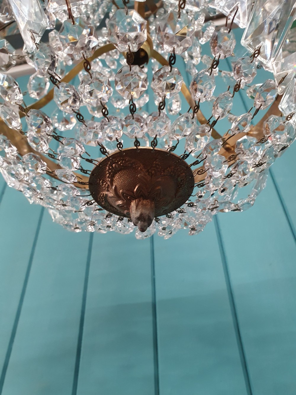 A cut glass crystal tent and bag chandelier featuring concentric tiers of glass beads suspended from a chased brass rim. View III