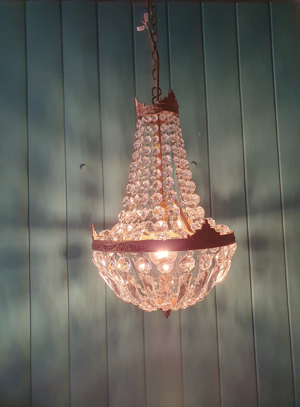 A cut glass crystal tent and bag chandelier featuring concentric tiers of glass beads suspended from a chased brass rim. View IV