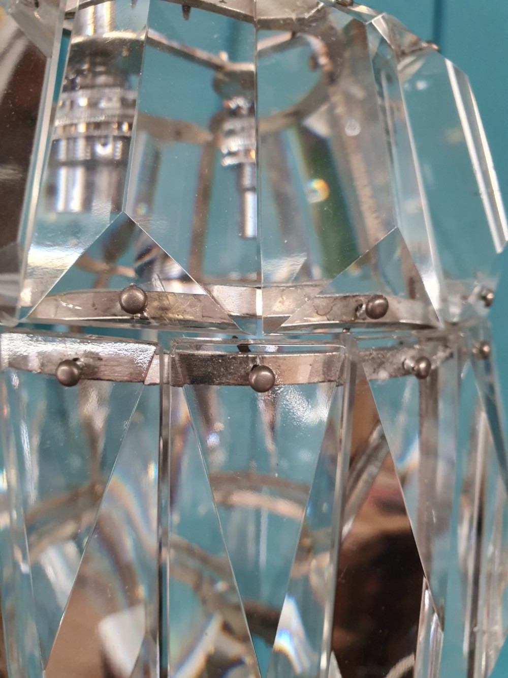 An early 20th-century small barrel-shaped crystal prism chandelier suspended by a brass link chain. View III