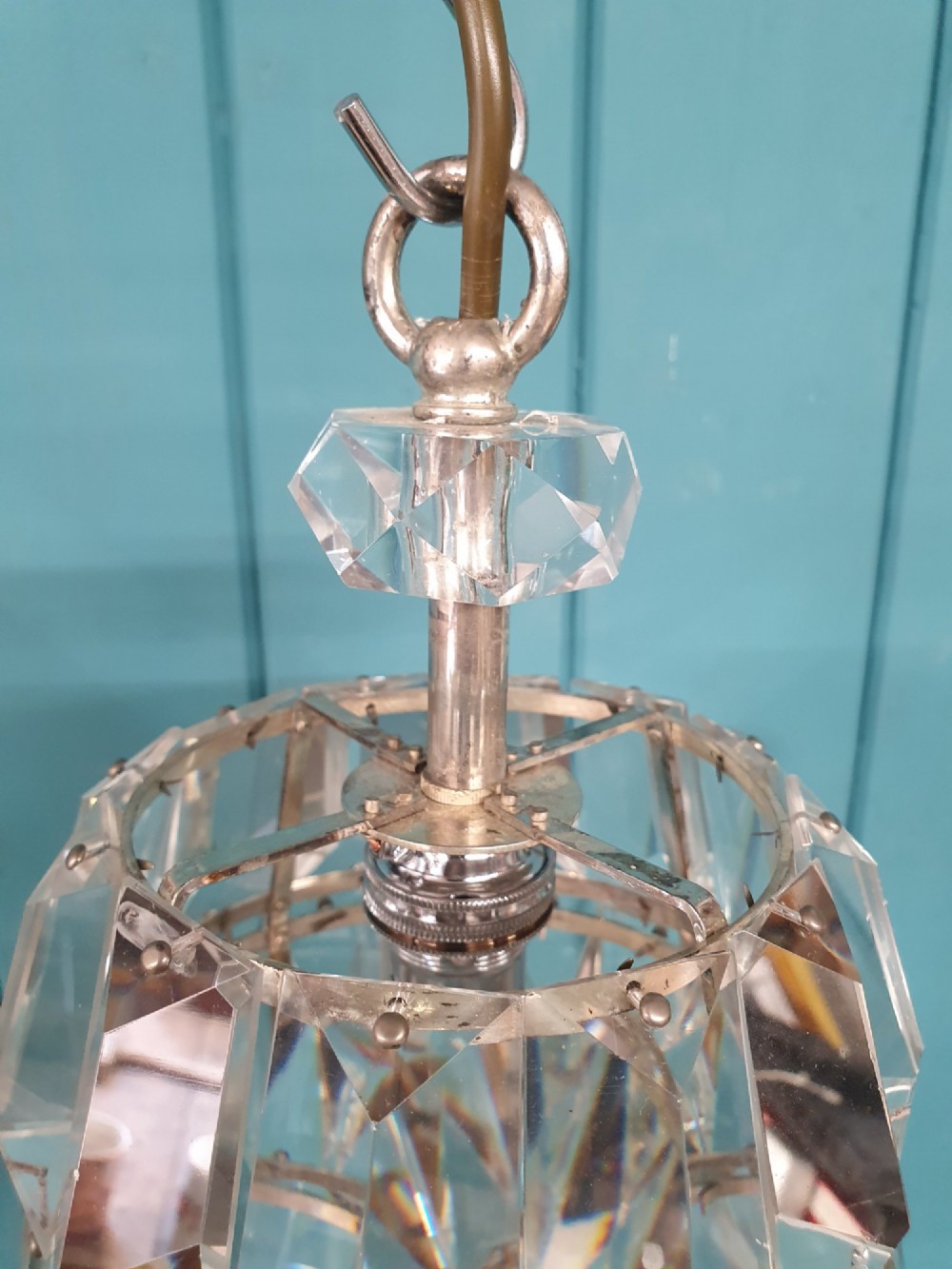 An early 20th-century small barrel-shaped crystal prism chandelier suspended by a brass link chain. View V