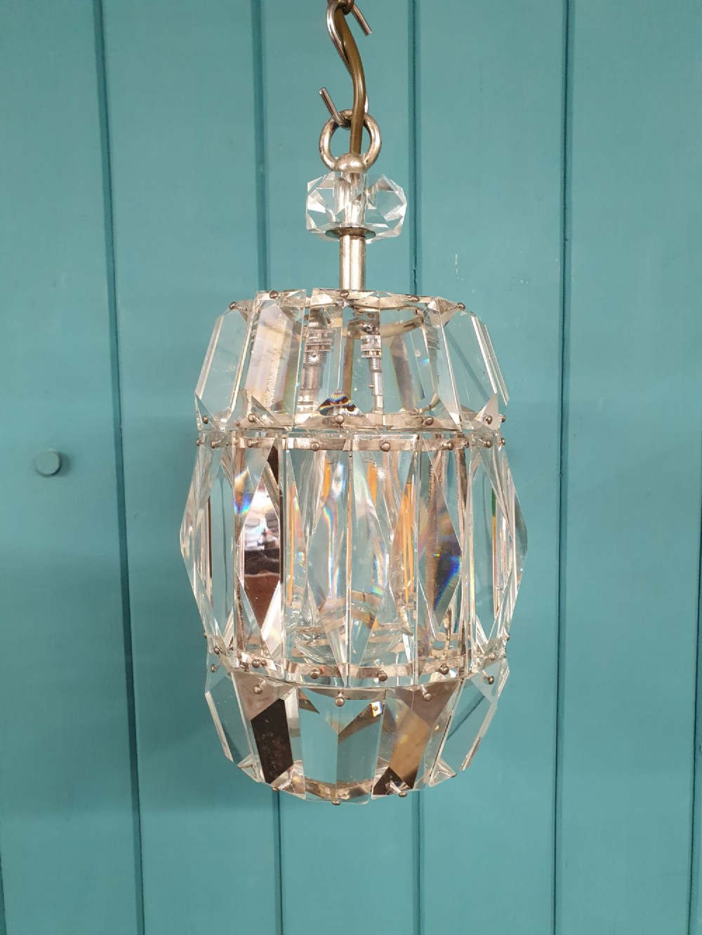 An early 20th-century small barrel-shaped crystal prism chandelier suspended by a brass link chain. View VII