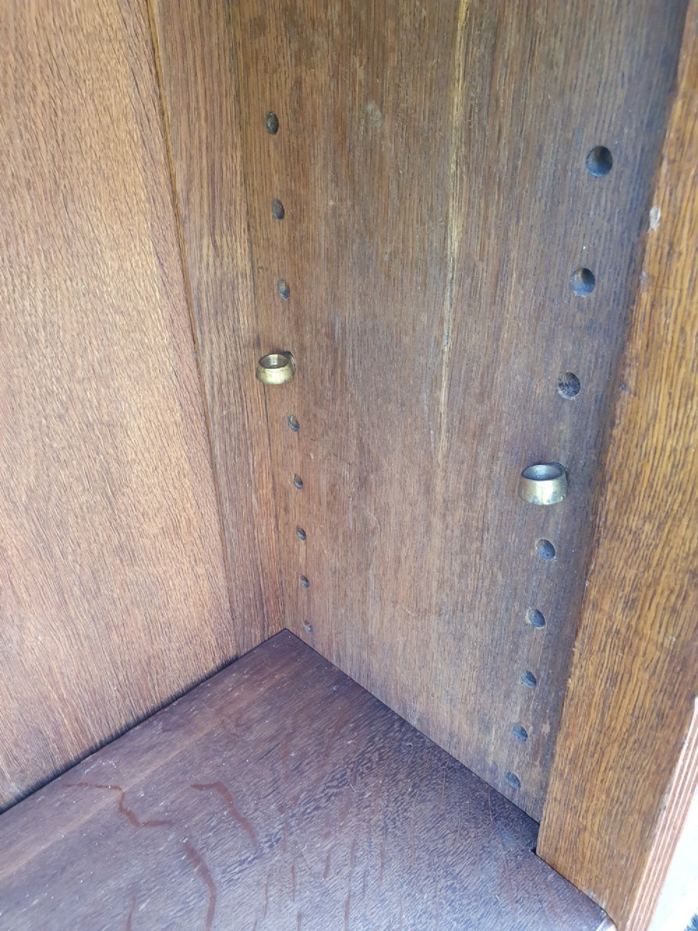 A pair of 19th-century low oak bookcases featuring carved scrollwork back galleries and open twin-bay shelving. View II