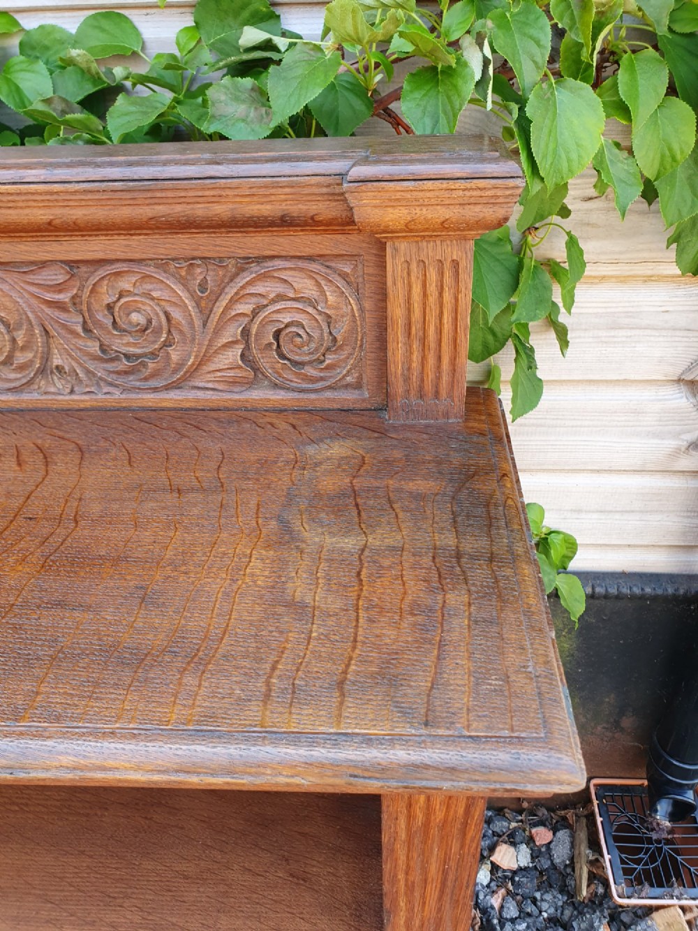 A pair of 19th-century low oak bookcases featuring carved scrollwork back galleries and open twin-bay shelving. View IV