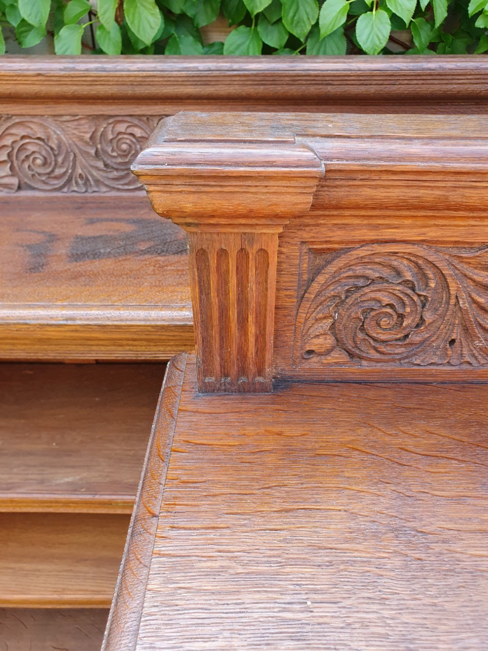 A pair of 19th-century low oak bookcases featuring carved scrollwork back galleries and open twin-bay shelving. View VII