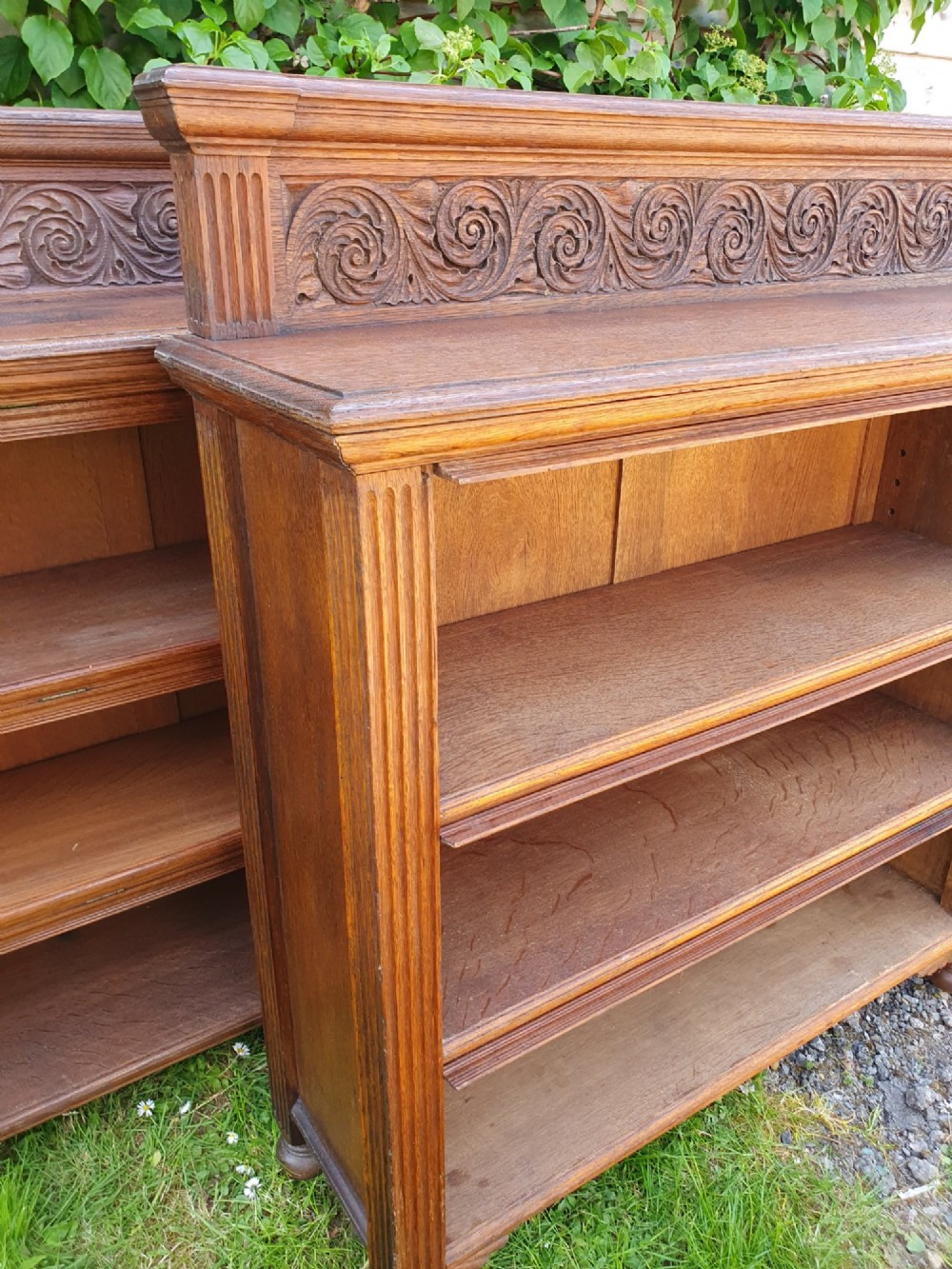 A pair of 19th-century low oak bookcases featuring carved scrollwork back galleries and open twin-bay shelving. View XI