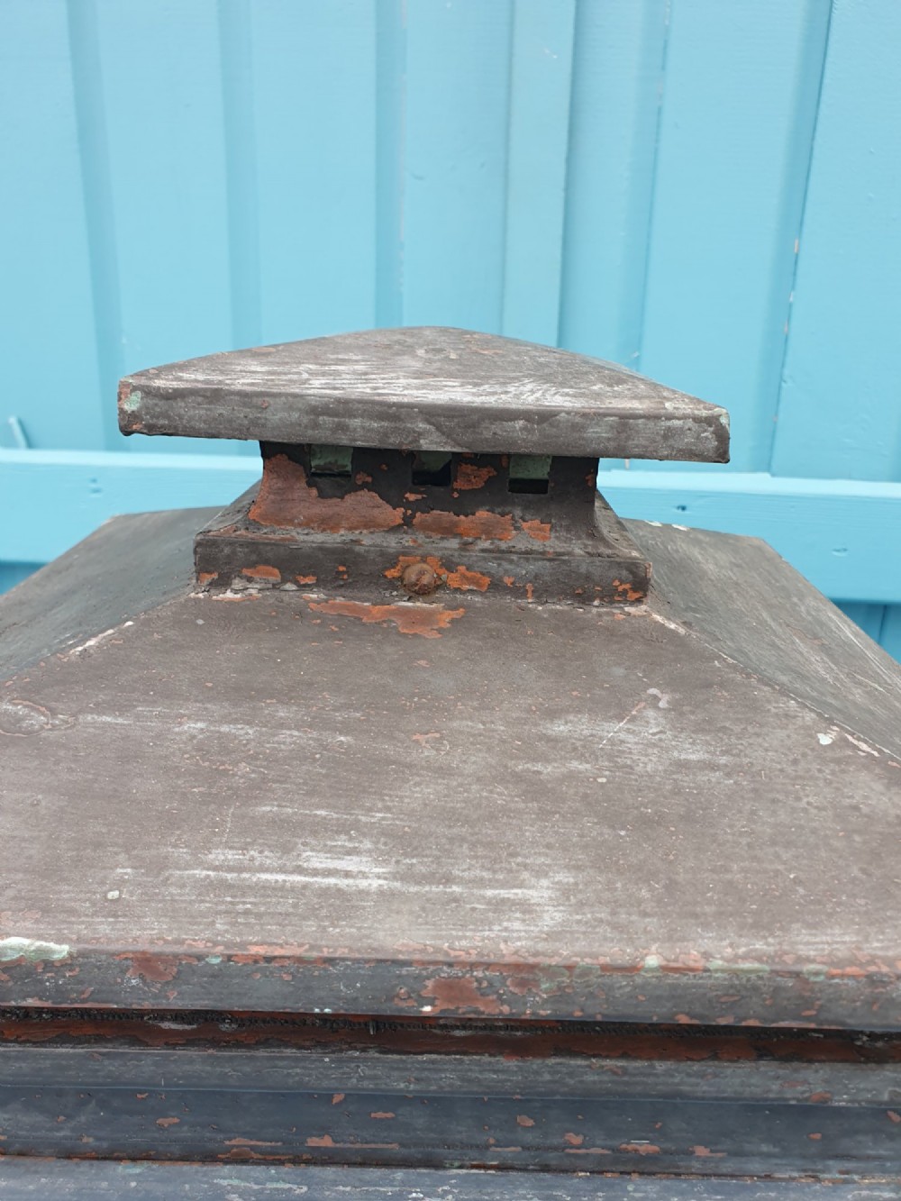 A Victorian weather-worn copper gas lantern converted for electric use, featuring clear glass panels and a stepped pyramidal top cowl supported by an iron mounting base. View VI
