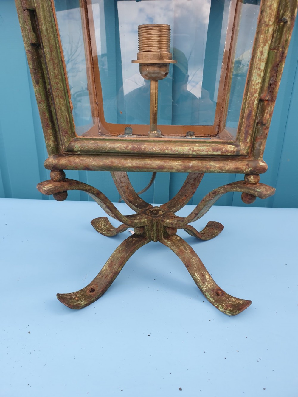 A Victorian green-painted metal garden lantern with glass panes and a tiered top cap, converted for electrical use and mounted on a decorative base. View IV