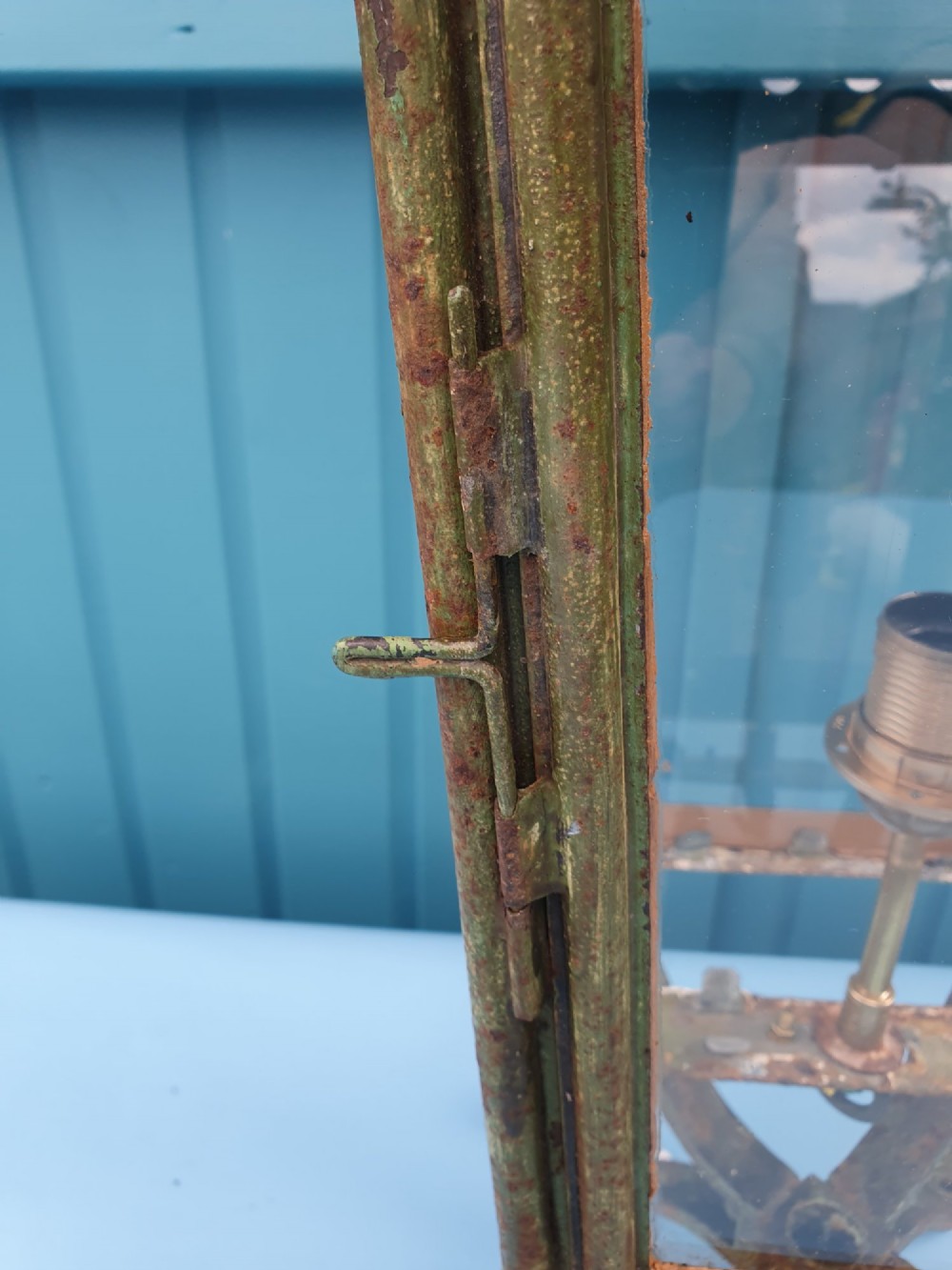 A Victorian green-painted metal garden lantern with glass panes and a tiered top cap, converted for electrical use and mounted on a decorative base. View V