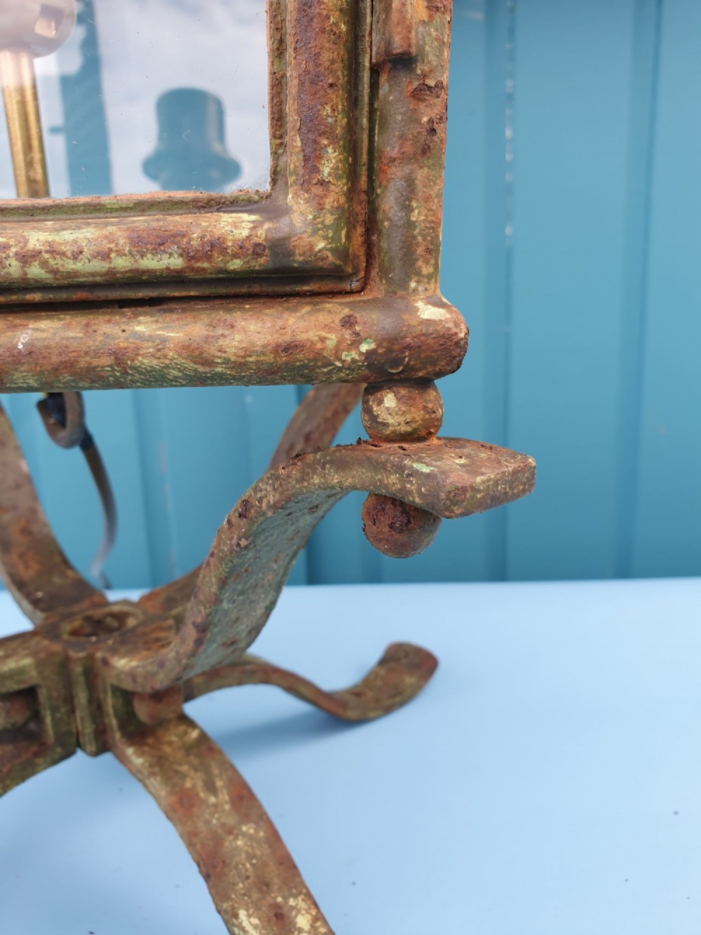 A Victorian green-painted metal garden lantern with glass panes and a tiered top cap, converted for electrical use and mounted on a decorative base. View VI