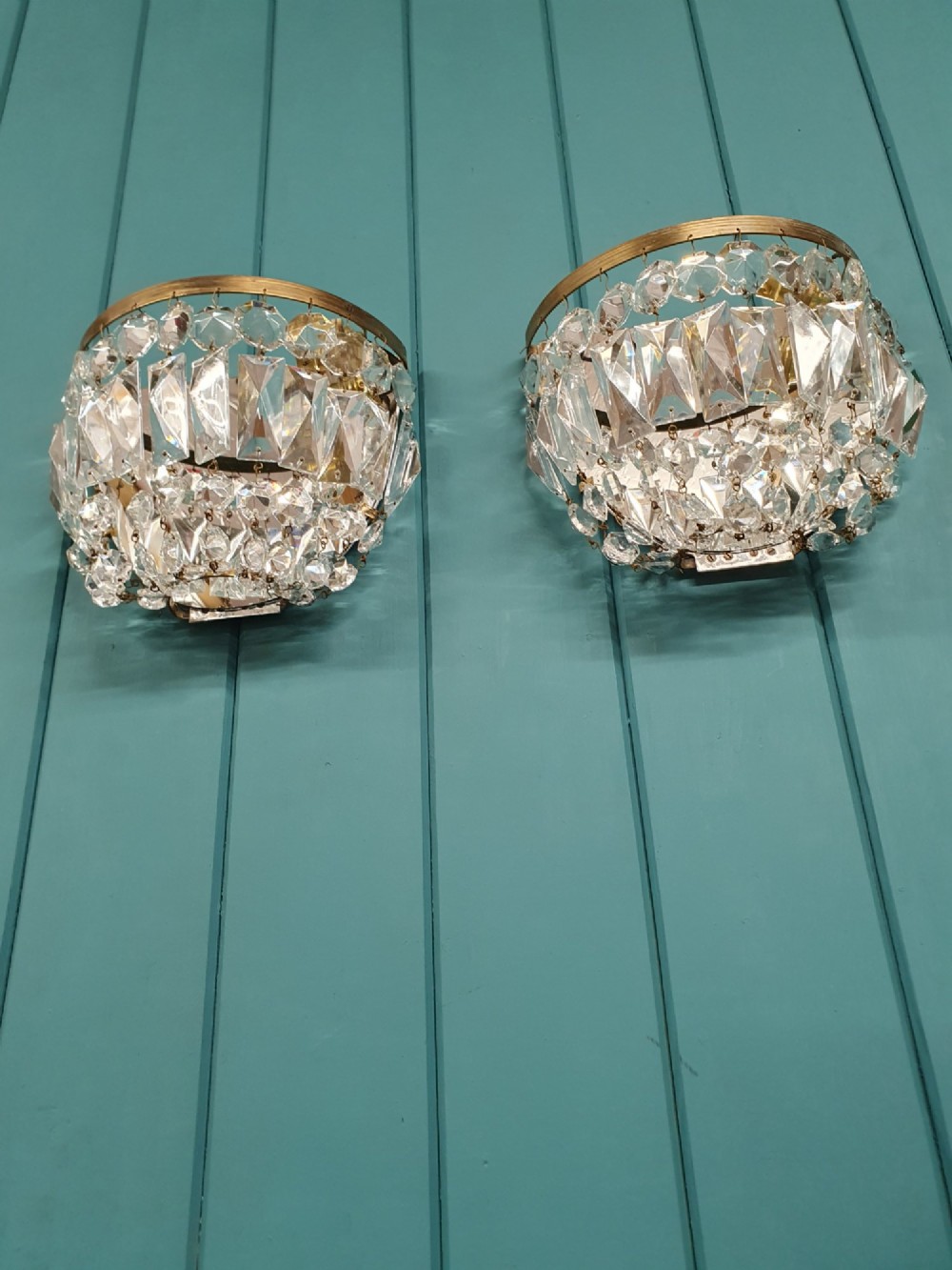 A pair of early 20th-century wall sconces featuring semi-circular brass frames hung with tiered cut-crystal prisms. View II