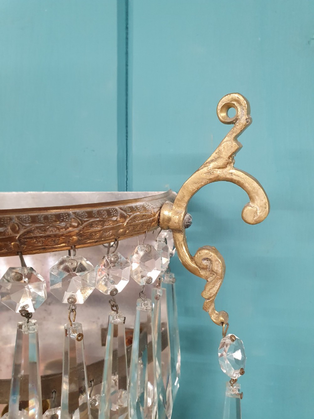 A pair of antique gilt brass wall lights featuring cascading concentric tiers of pointed crystal glass prisms. View VI