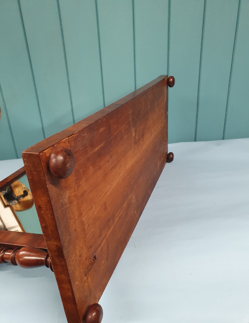A 19th-century rectangular mahogany dressing mirror with turned side posts resting on a flat plinth base. View II