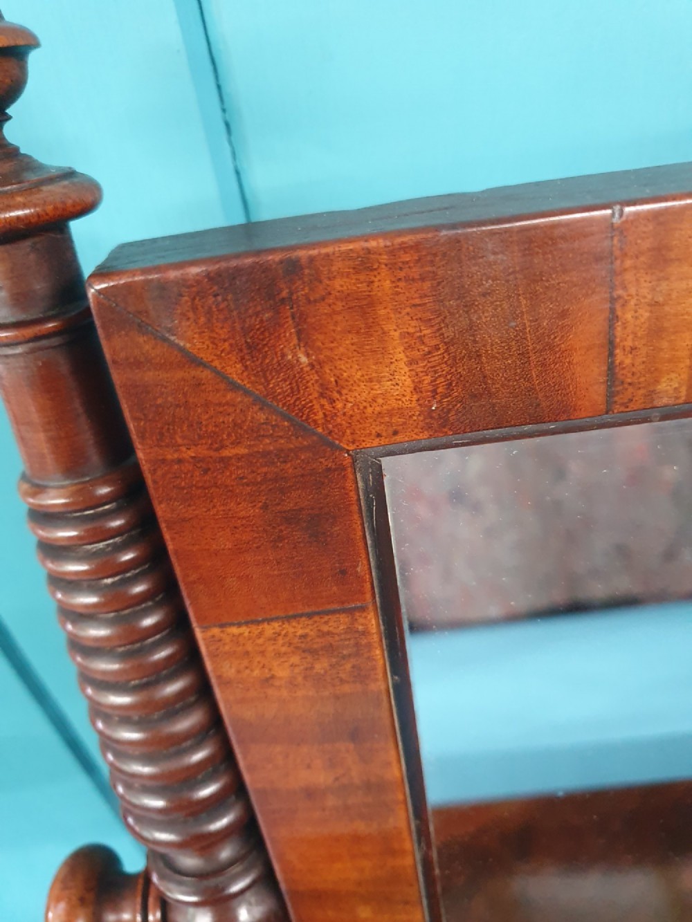 A 19th-century rectangular mahogany dressing mirror with turned side posts resting on a flat plinth base. View V