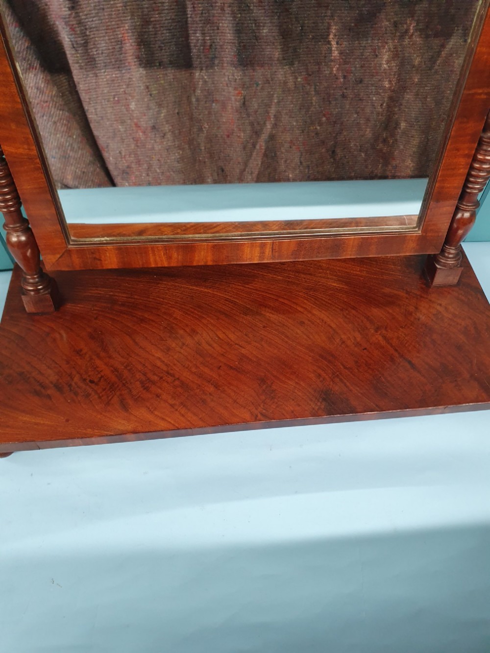 A 19th-century rectangular mahogany dressing mirror with turned side posts resting on a flat plinth base. View VI