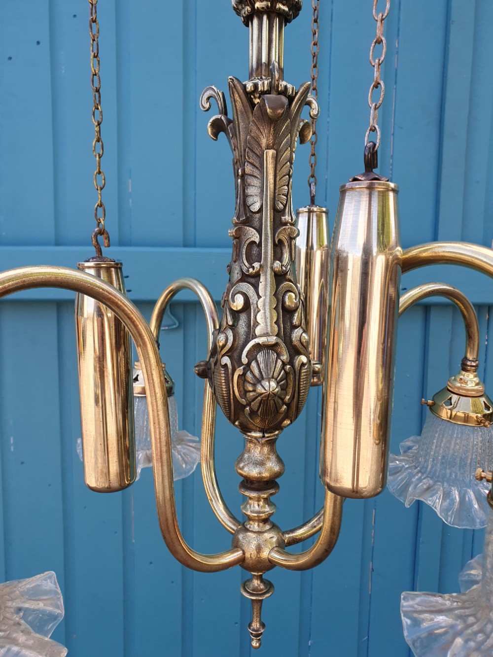 An antique brass four-arm rise and fall chandelier with curved arms, ruffled glass shades, and a counterweight pulley mechanism. View III