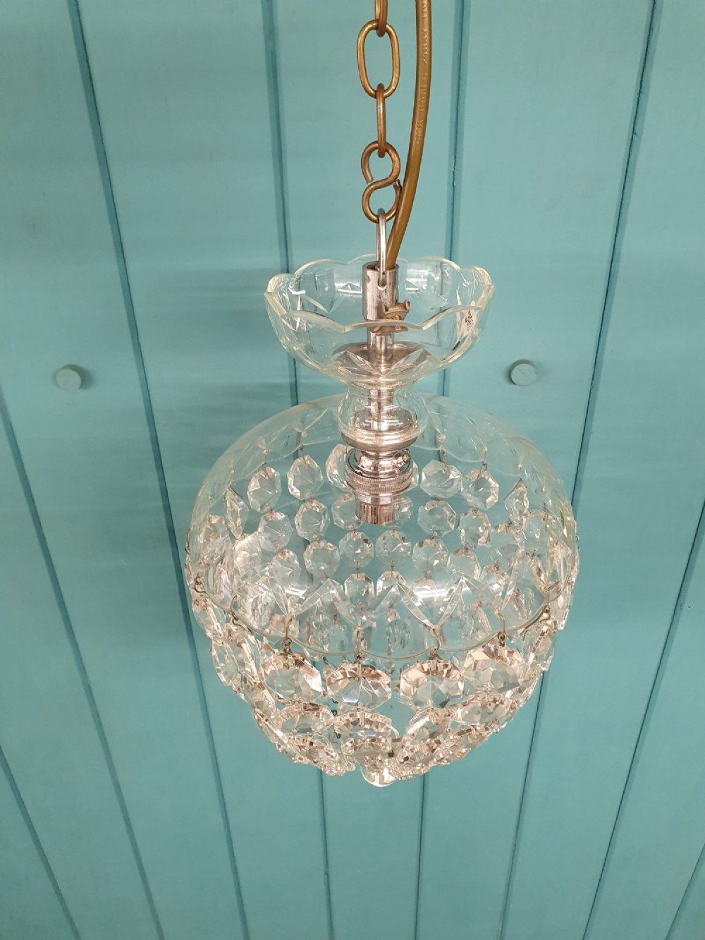 An early 20th-century crystal dome top pendant chandelier with faceted glass beads and a brass chain suspension. View V