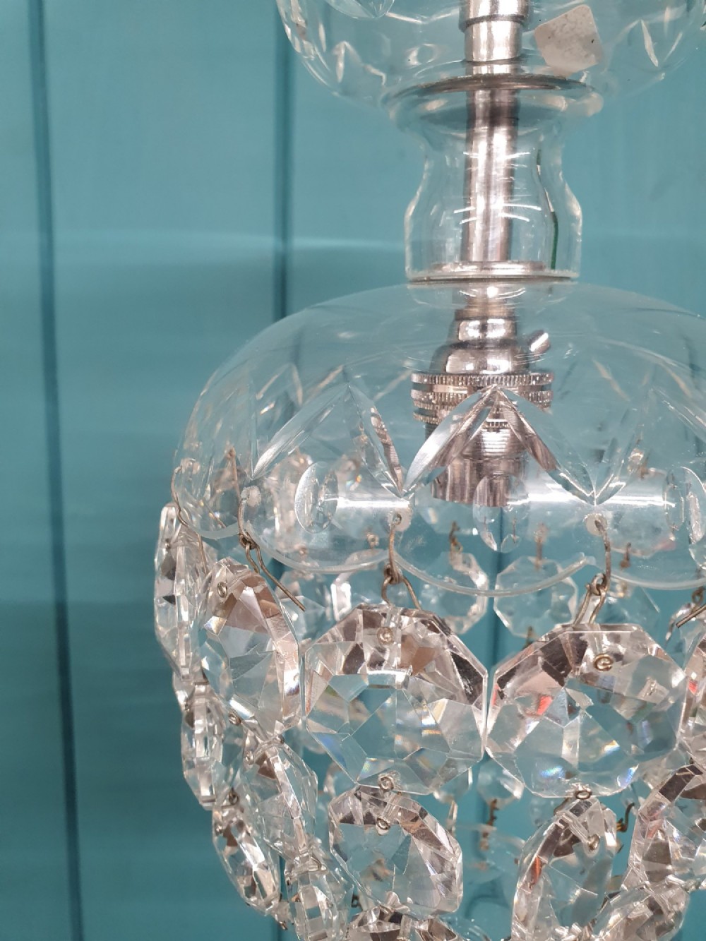 An early twentieth-century clear glass dome top chandelier featuring faceted crystal drops and a suspended hanging brass chain. View IV