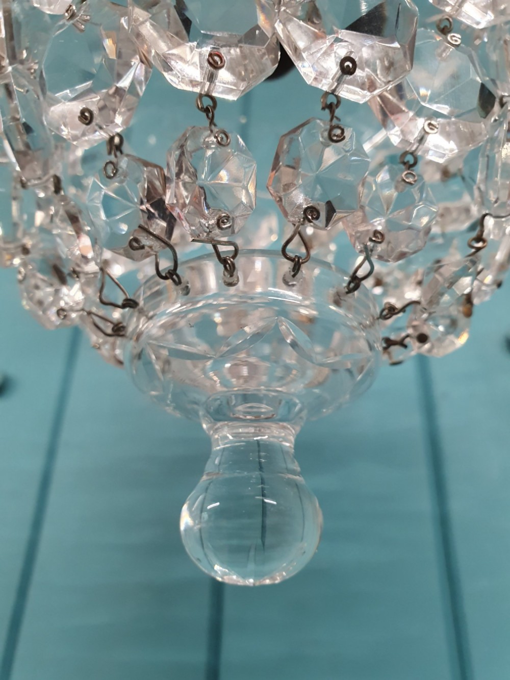 An early twentieth-century clear glass dome top chandelier featuring faceted crystal drops and a suspended hanging brass chain. View V