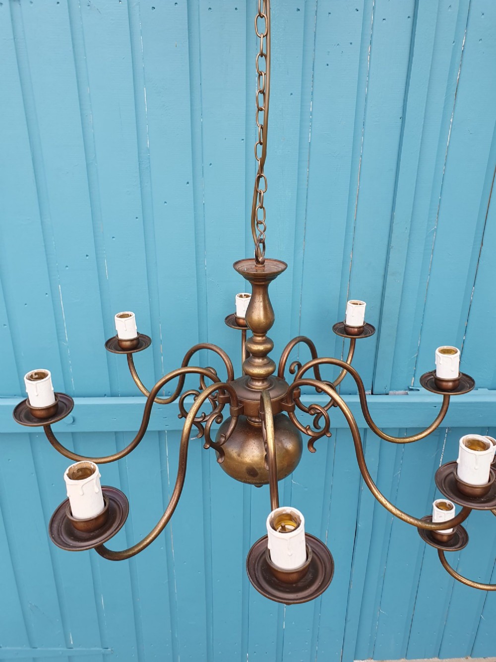 A pair of antique Dutch Flemish brass chandeliers featuring multi-arm S-scroll branches and central baluster stems with hanging chains. View II