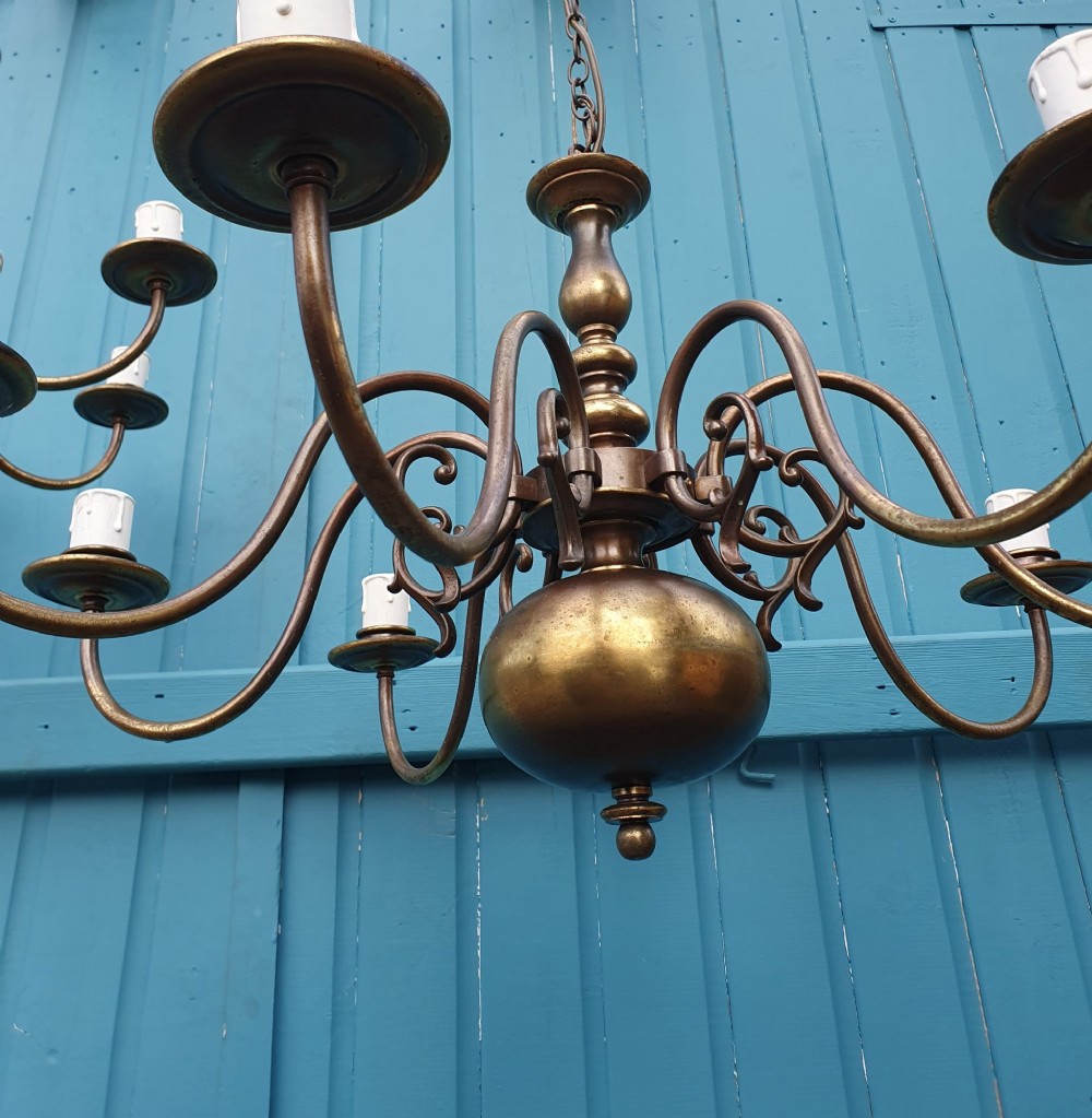 A pair of antique Dutch Flemish brass chandeliers featuring multi-arm S-scroll branches and central baluster stems with hanging chains. View III