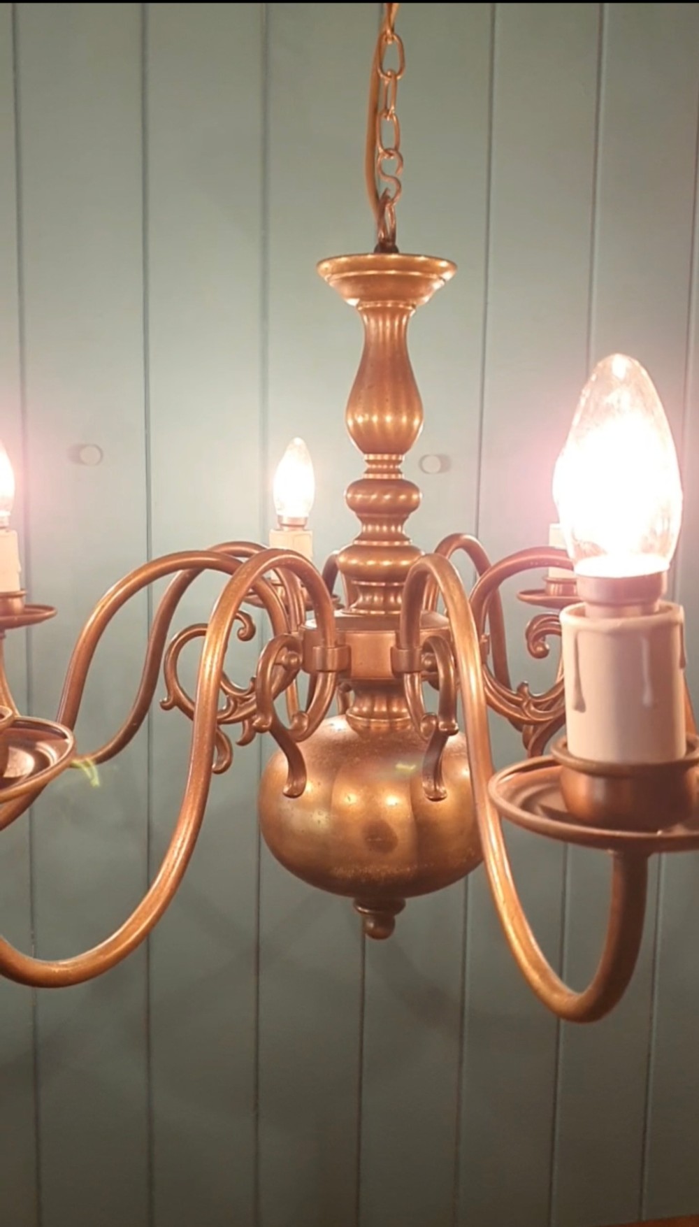 A pair of antique Dutch Flemish brass chandeliers featuring multi-arm S-scroll branches and central baluster stems with hanging chains. View VI