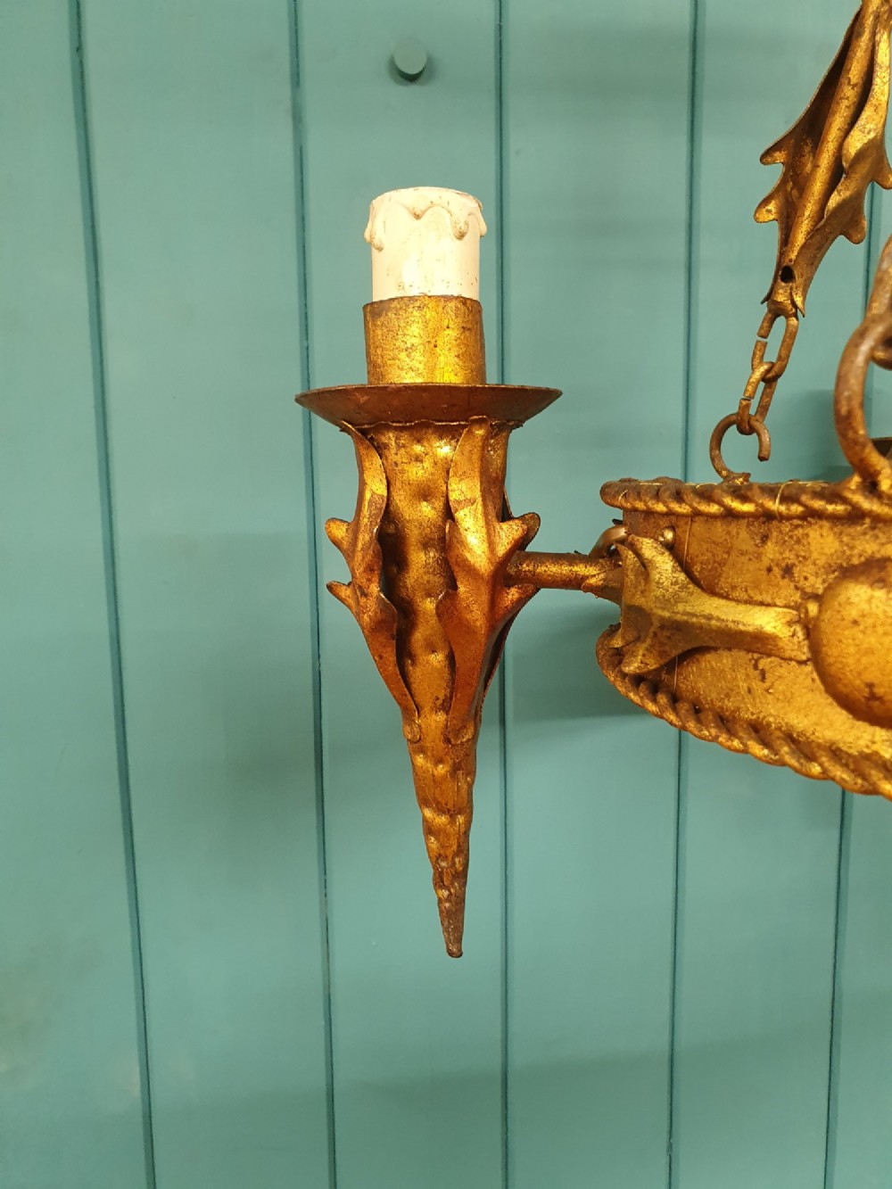 A late 19th-century French gilded metal coronet chandelier featuring a circular band adorned with leaf motifs and four candle-style light sockets suspended by chains. View II