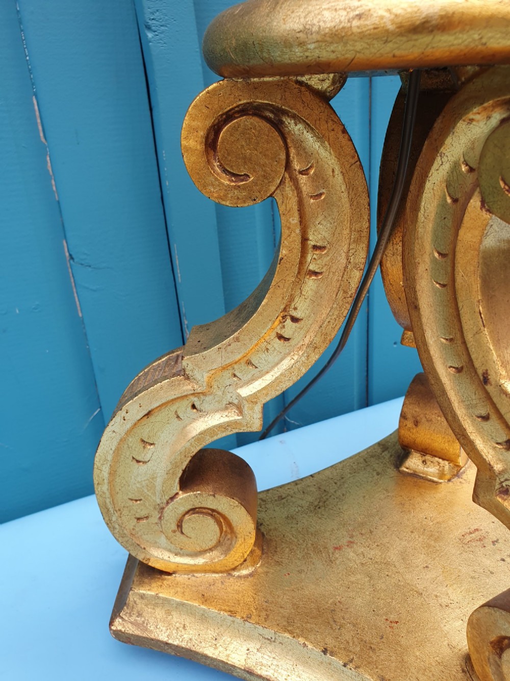 A late nineteenth-century carved giltwood standard lamp featuring a fluted column, ornamental knops, and a scroll-carved tripod base. View V