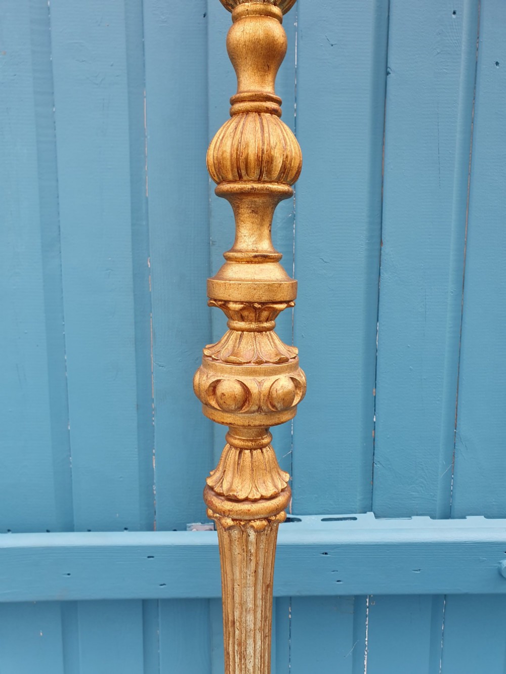 A late nineteenth-century carved giltwood standard lamp featuring a fluted column, ornamental knops, and a scroll-carved tripod base. View VII